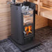 The fire glowing behind the cast-iron-framed glass door adds to the atmosphere of the sauna